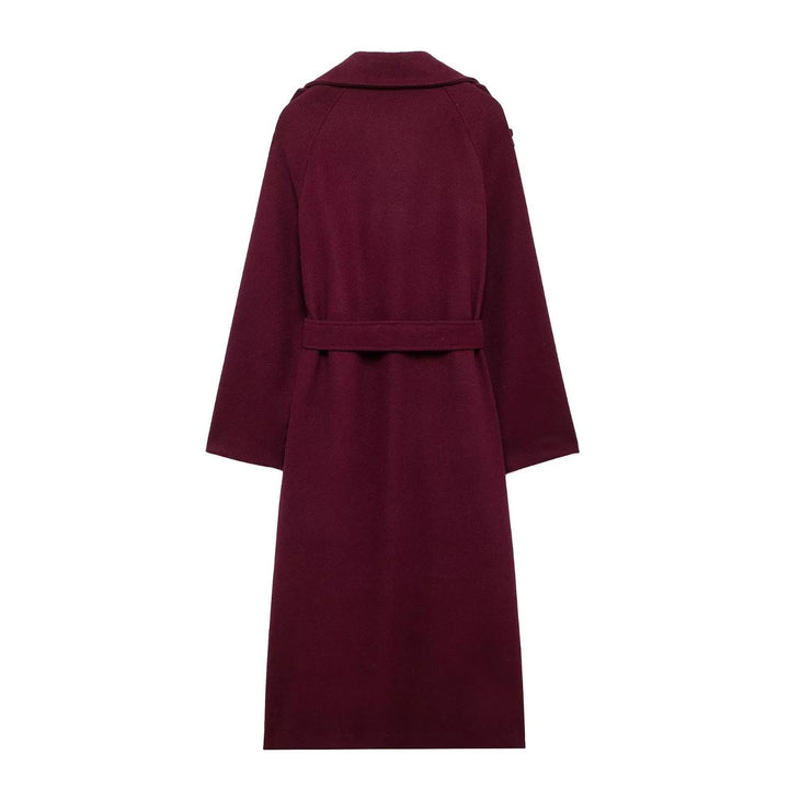 Woman wearing wine red long double-breasted trench coat with belt