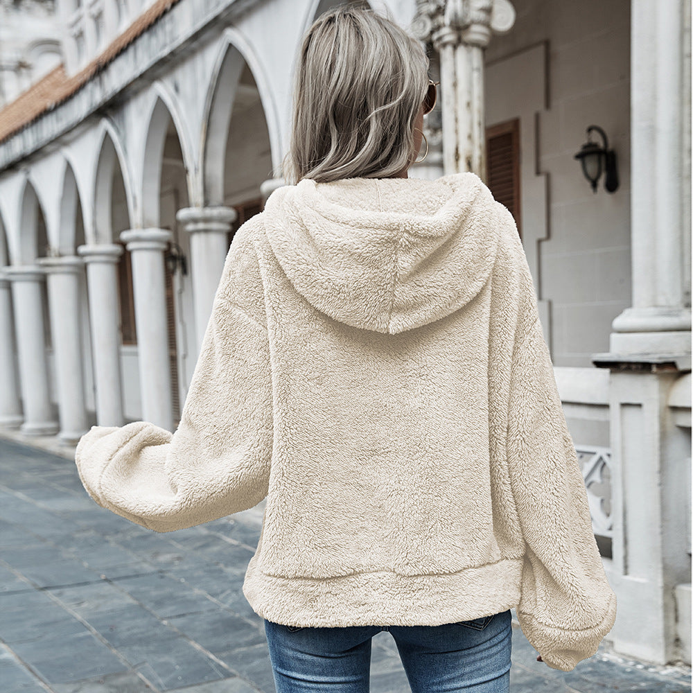 Woman wearing apricot plush hooded sweater with drawstring hood