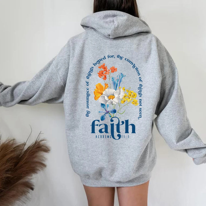 Woman wearing Bible verse graphic hoodie with long sleeves