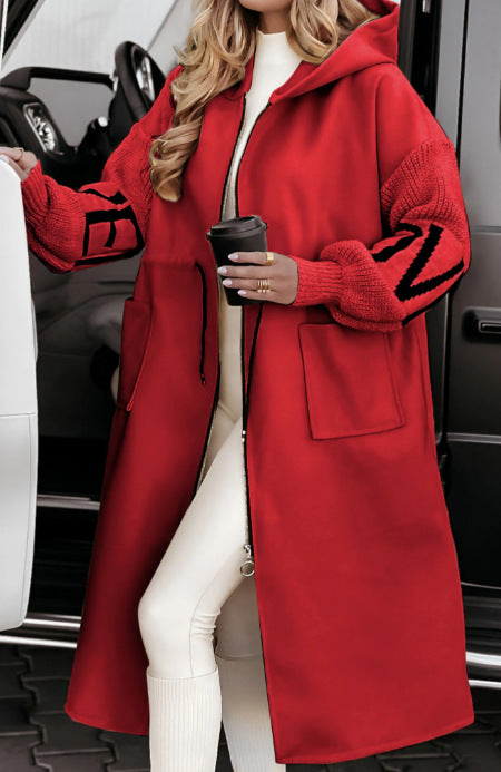 Woman wearing long hooded trench coat with drawstring detail