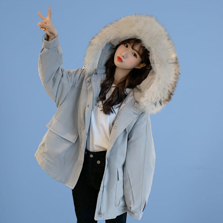 Woman wearing loose hooded winter coat in neutral tones
