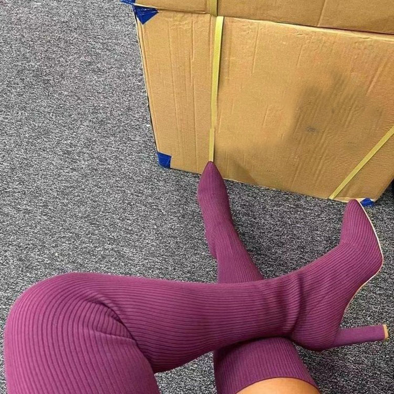 Woman wearing pointed toe over the knee high heel boots