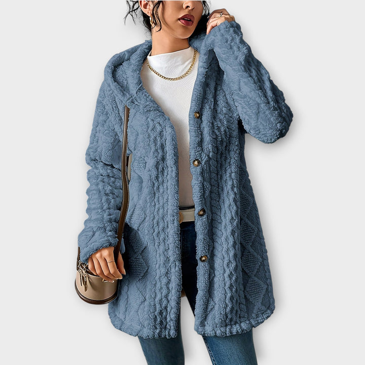 Woman wearing textured hooded winter jacket in relaxed fit