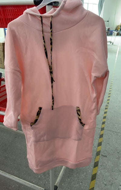 Woman wearing hooded sweatshirt dress with leopard-print drawstrings