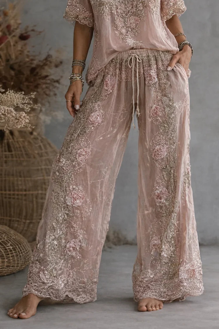 Woman wearing floral embroidered V-neck top and wide leg pants
