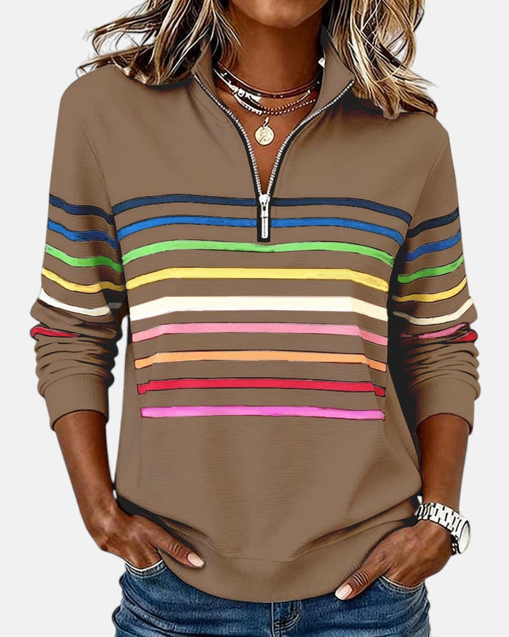 Woman wearing rainbow striped half zip sweatshirt
