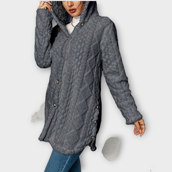 Woman wearing textured hooded winter jacket in relaxed fit