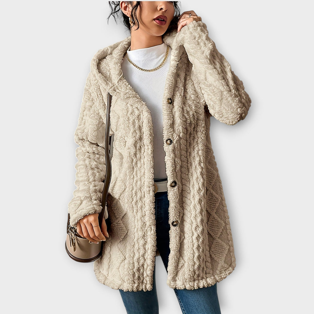 Woman wearing textured hooded winter jacket in relaxed fit