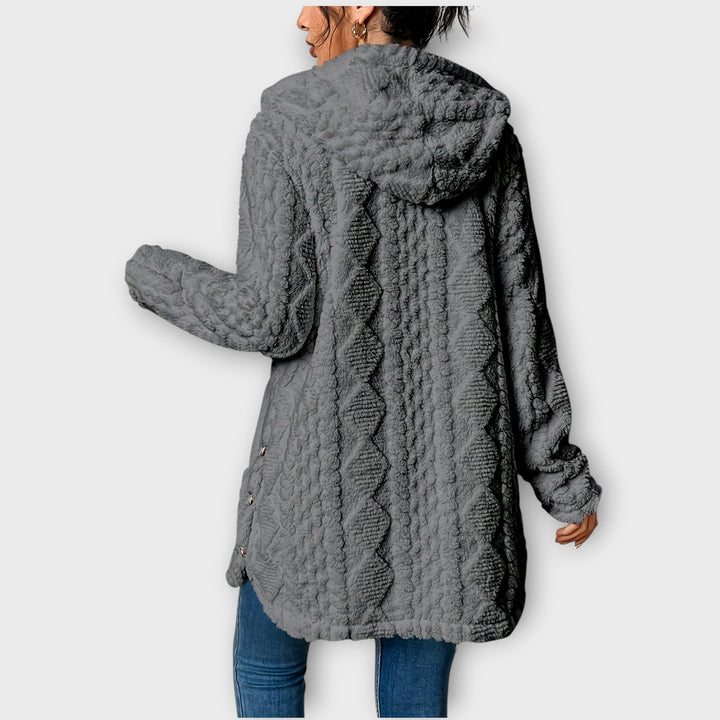 Woman wearing textured hooded winter jacket in relaxed fit