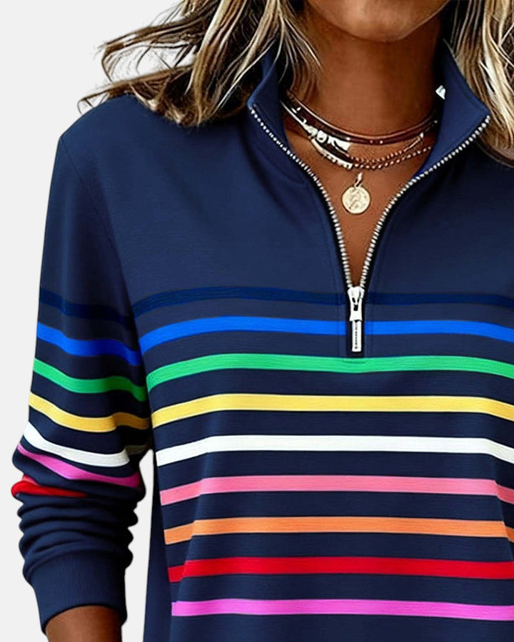 Woman wearing rainbow striped half zip sweatshirt