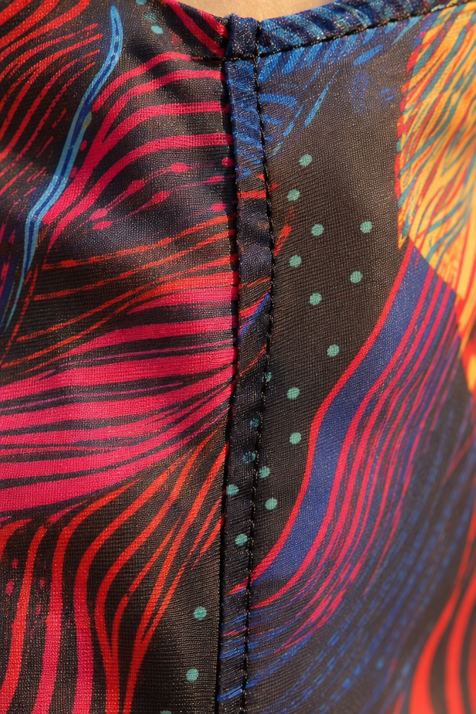 Woman wearing multicolor sheer mesh maxi dress indoors