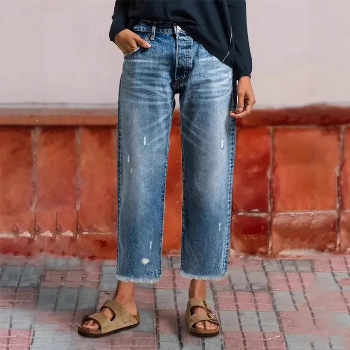 Woman wearing cropped straight leg jeans with light faded wash