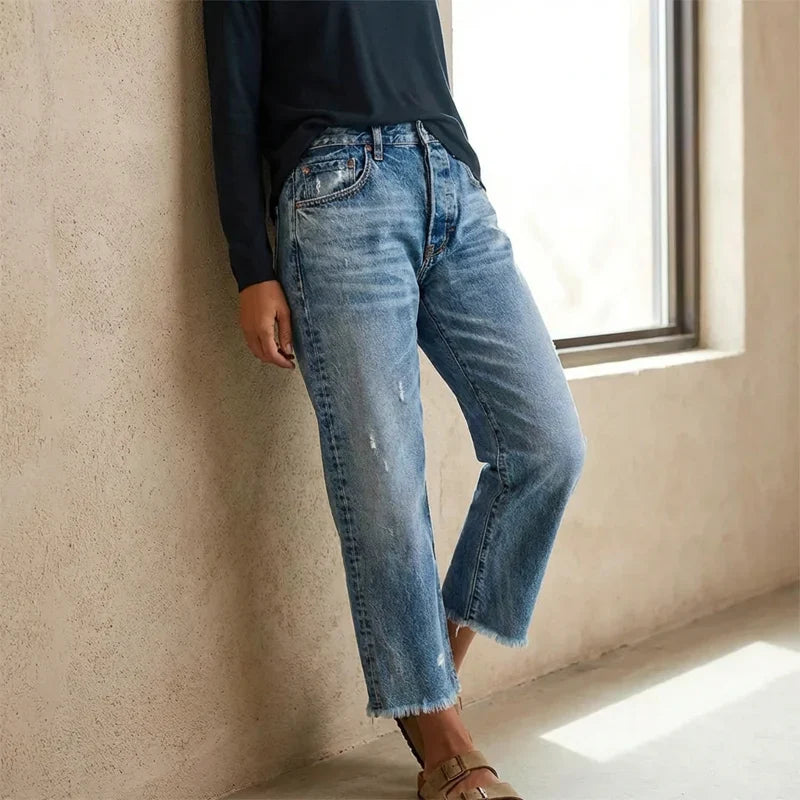 Woman wearing cropped straight leg jeans with light faded wash