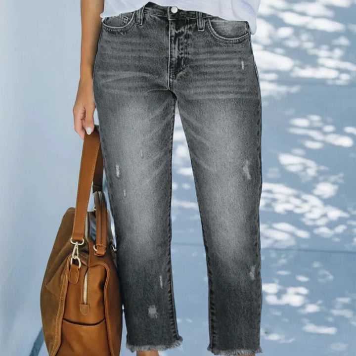 Woman wearing cropped straight leg jeans with light faded wash